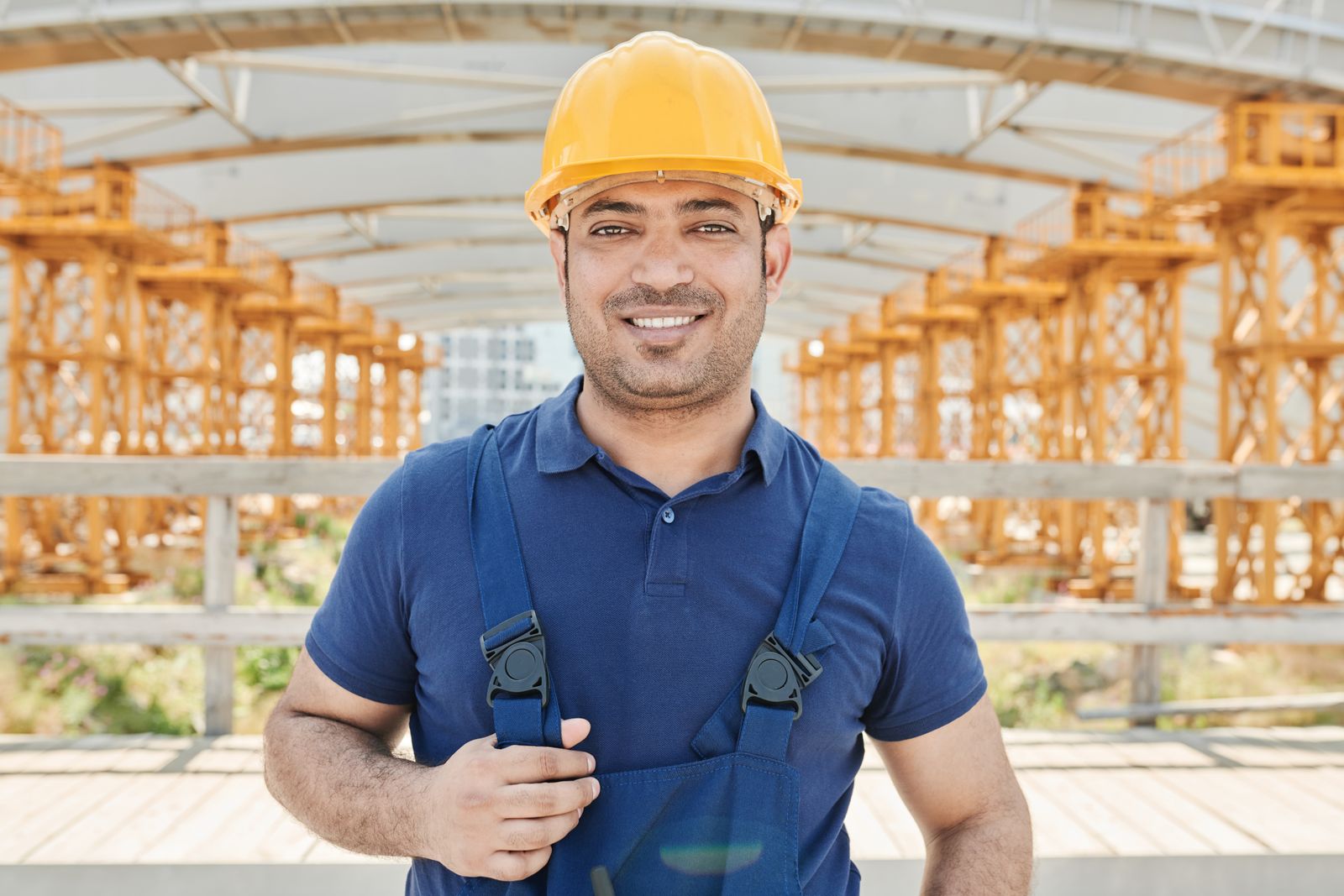 Smiling HVAC technician in uniform and hard hat