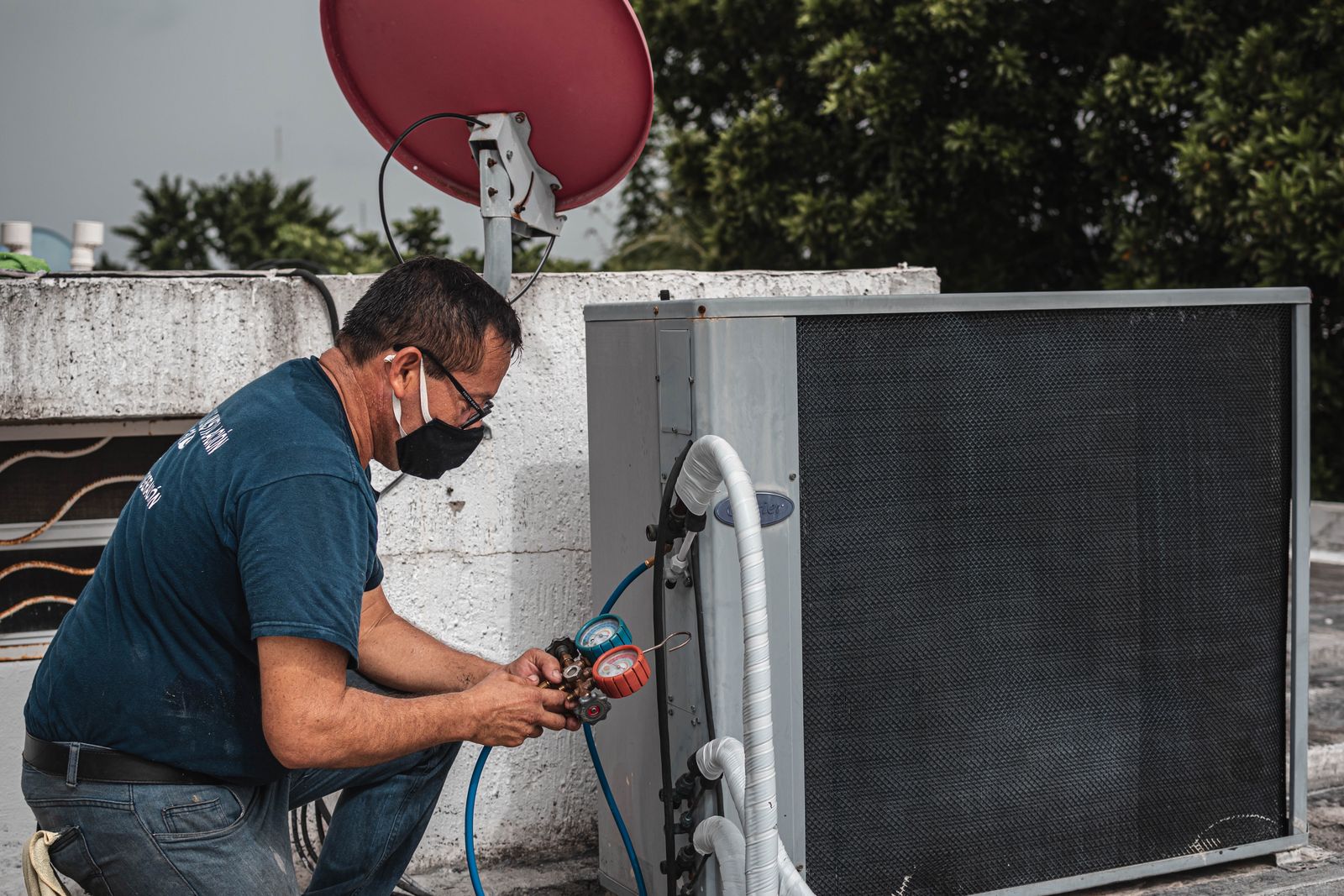 Technician repairing an outdoor AC condenser unit