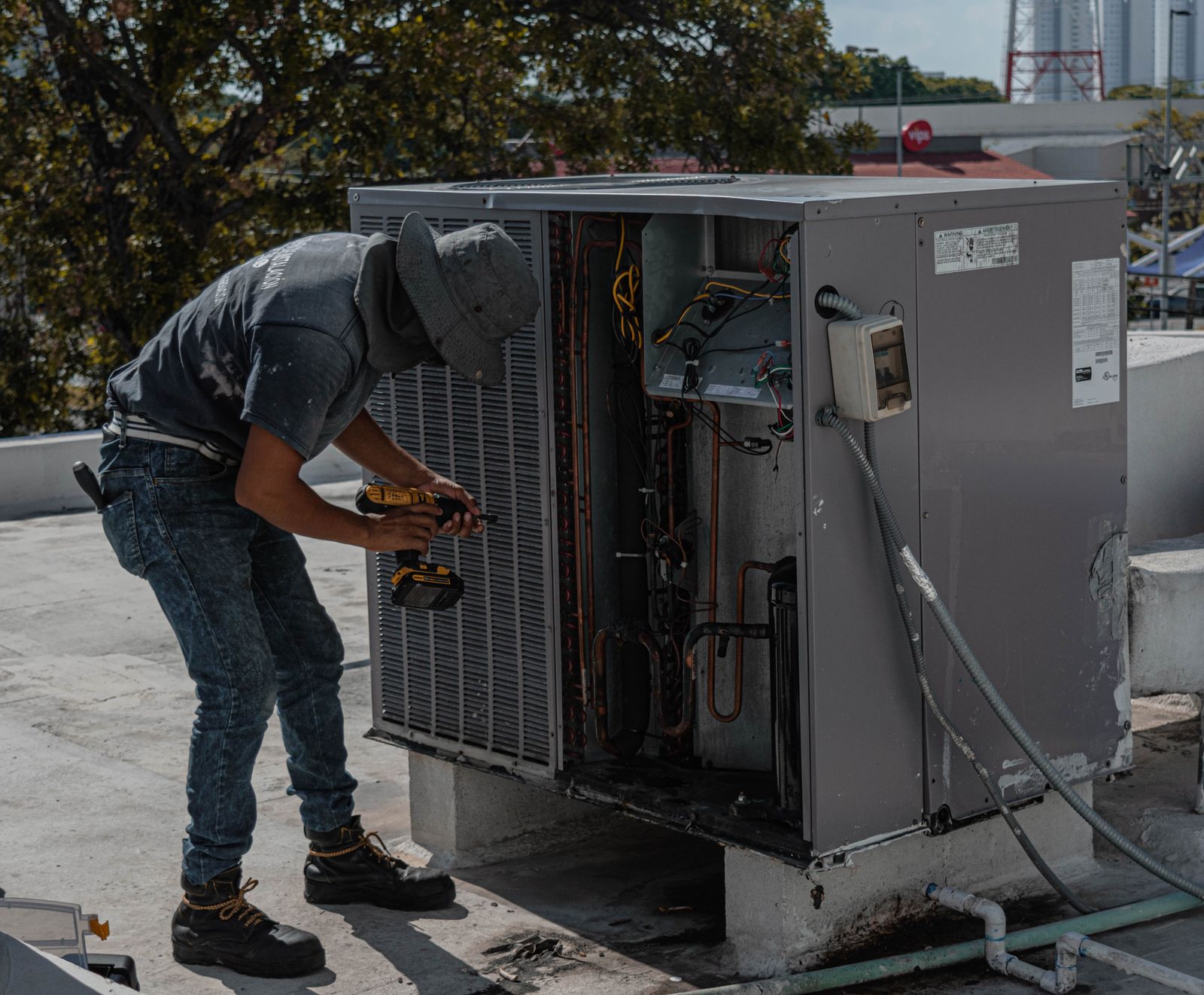 HVAC technician servicing a rooftop air conditioning unit