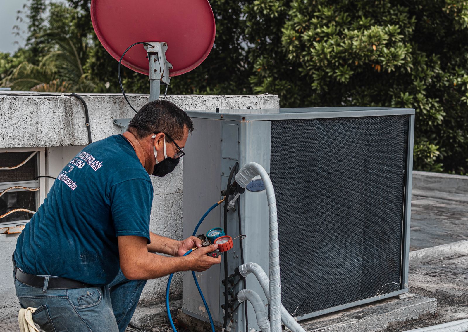 Technician inspecting an outdoor air conditioner during a tune-up
